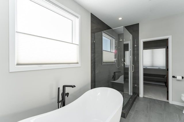 bathroom with a soaking tub, a shower stall, and recessed lighting