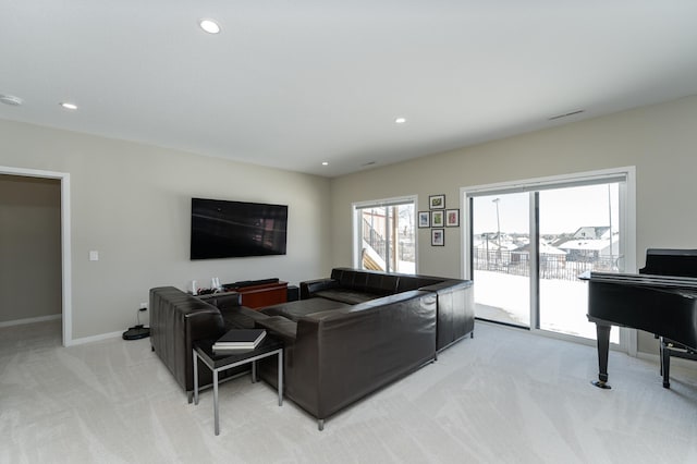 living area with light carpet, visible vents, baseboards, and recessed lighting