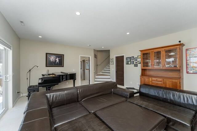 living room with recessed lighting, visible vents, stairway, and baseboards