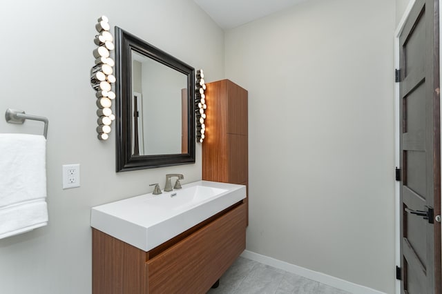 bathroom featuring baseboards and vanity