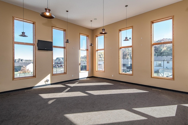 unfurnished room featuring visible vents, baseboards, and carpet flooring