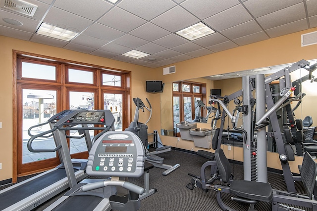 workout area with visible vents and a drop ceiling