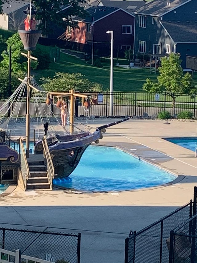 community pool with playground community and fence