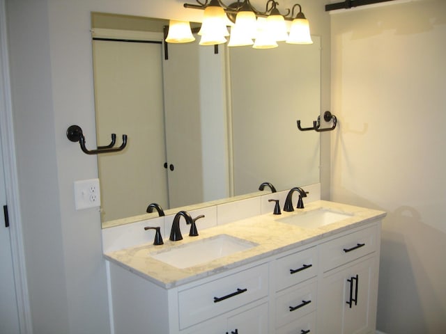 bathroom featuring a sink and double vanity