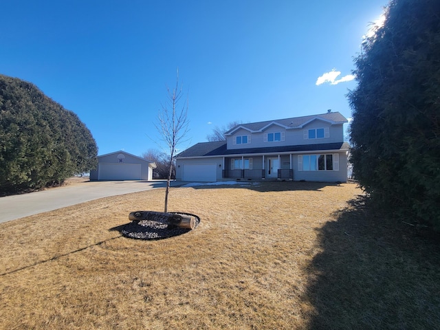 view of front of property featuring a garage, driveway, a porch, and a front yard