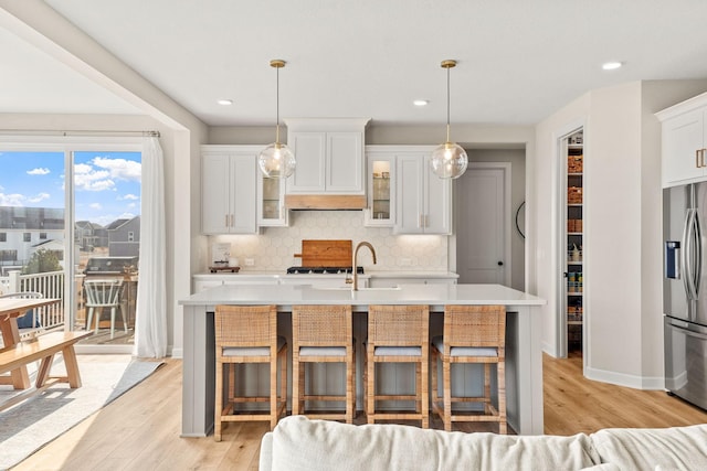 kitchen with light countertops, appliances with stainless steel finishes, and decorative backsplash