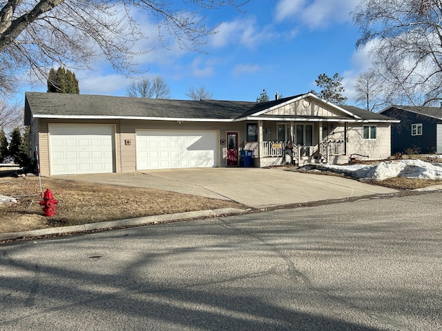 view of front of home featuring concrete driveway, a porch, and an attached garage