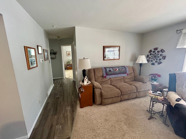 living area featuring baseboards and wood finished floors