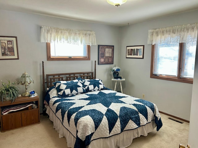 bedroom featuring carpet flooring, visible vents, and baseboards