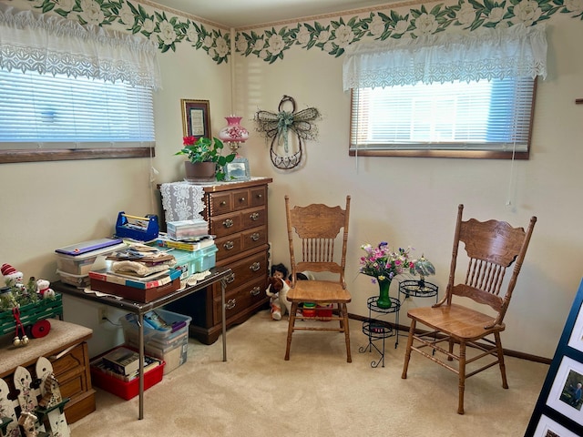 sitting room with carpet floors, baseboards, and a wealth of natural light