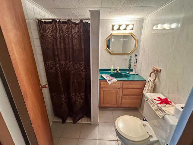 bathroom with toilet, a shower with curtain, vanity, and tile patterned floors