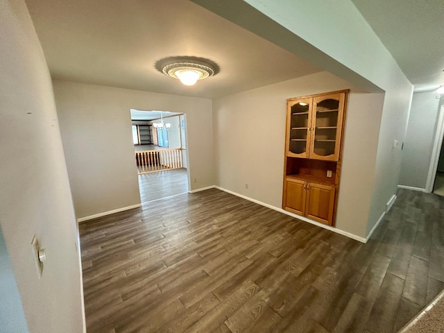 1006 10th St SW, Wadena, MN 56482 - empty room featuring dark wood-style flooring and a chandelier