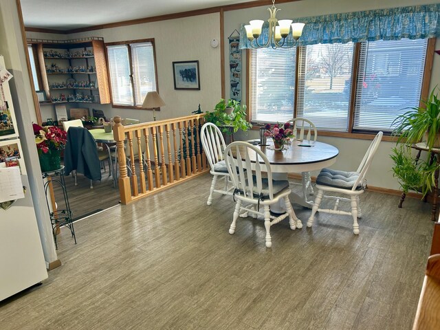 1006 10th St SW, Wadena, MN 56482 - dining room featuring a chandelier, wood finished floors, and ornamental molding