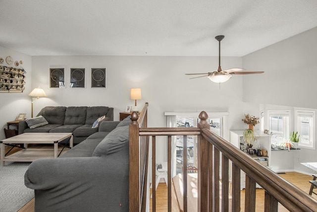 living room featuring plenty of natural light, light wood-style floors, and ceiling fan