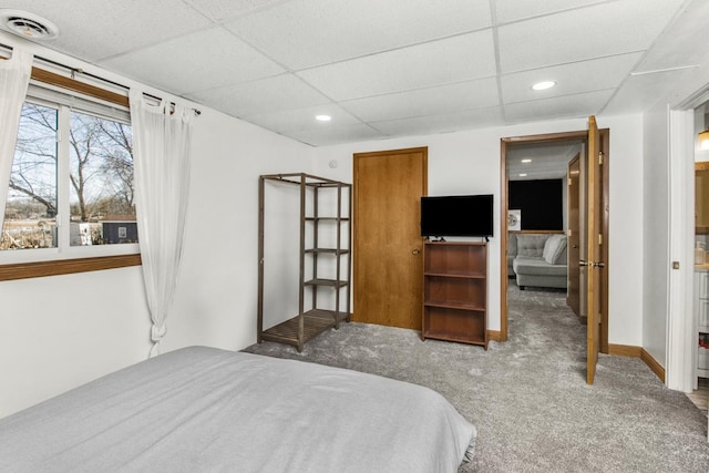 carpeted bedroom featuring recessed lighting, baseboards, visible vents, and a drop ceiling