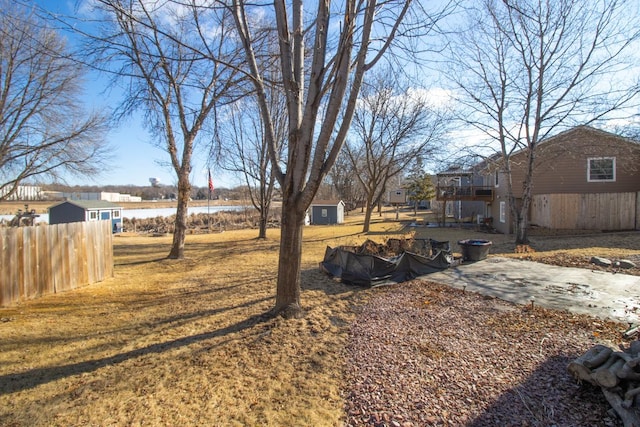 view of yard with a patio area, fence, and a wooden deck