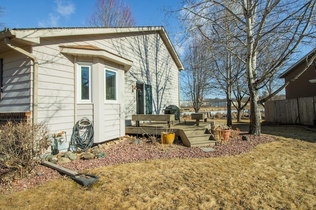 view of side of home featuring fence