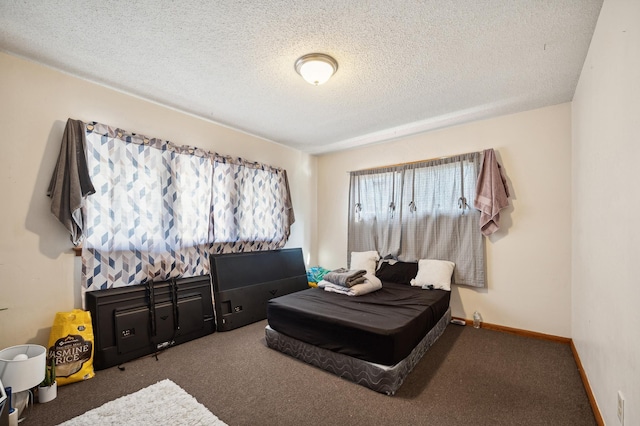 carpeted bedroom with baseboards and a textured ceiling