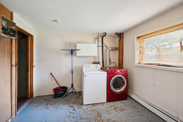 laundry room featuring cabinet space, washer and clothes dryer, baseboard heating, and a textured ceiling