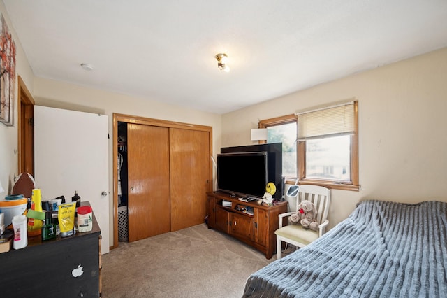 bedroom with light carpet and a closet