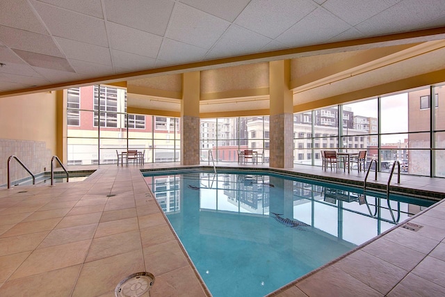 pool with a view of city and a patio area