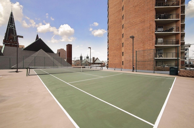 view of sport court featuring community basketball court and fence