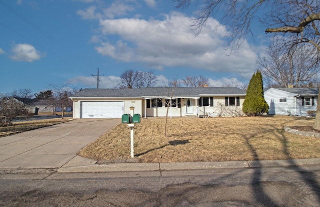 ranch-style house featuring a garage, driveway, a porch, and a front yard