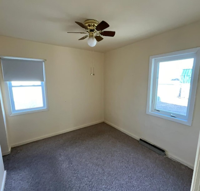 empty room with a wealth of natural light, baseboards, ceiling fan, and carpet flooring