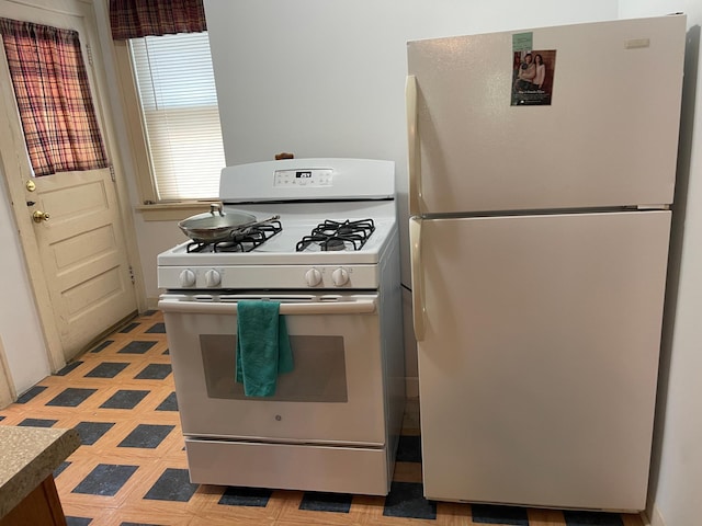 kitchen with white appliances and light floors