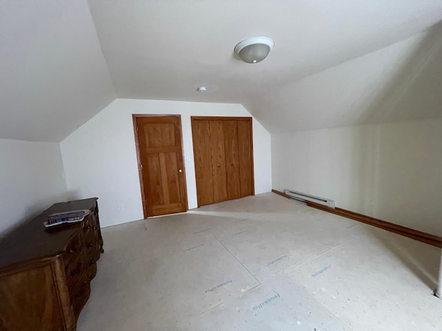 bonus room with a baseboard heating unit and vaulted ceiling