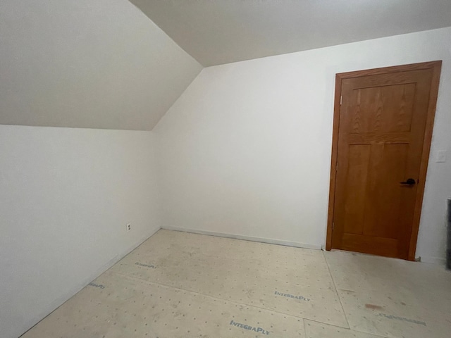 additional living space featuring vaulted ceiling