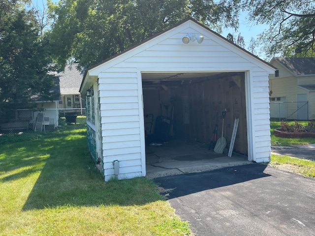 detached garage with driveway and fence