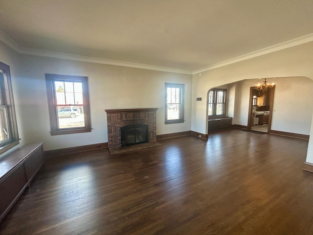 unfurnished living room with a fireplace, baseboards, dark wood-type flooring, and ornamental molding