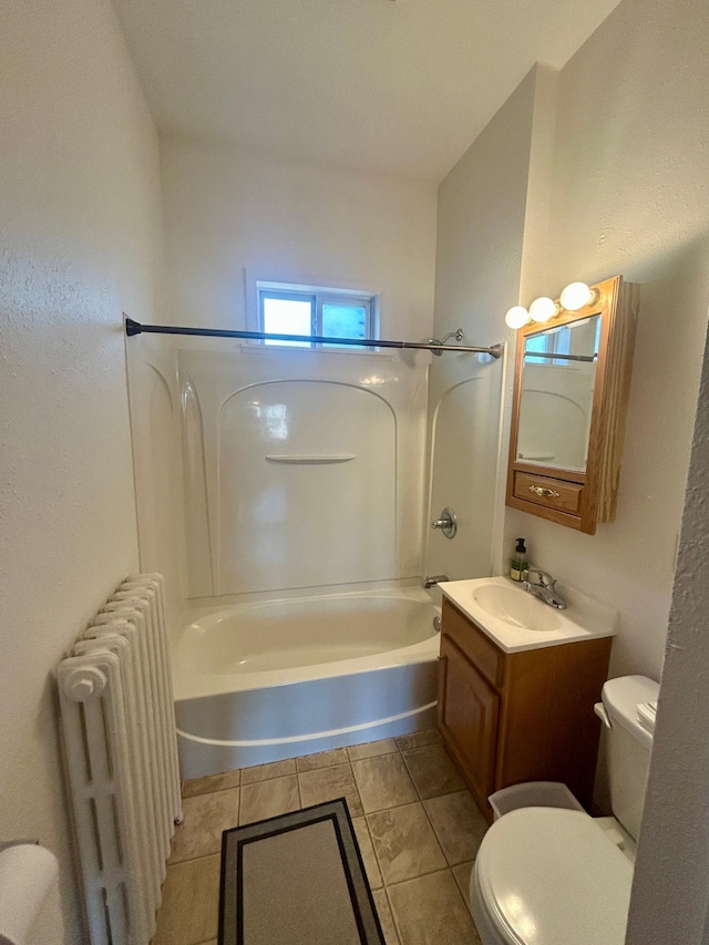 full bathroom with washtub / shower combination, toilet, vanity, and radiator heating unit