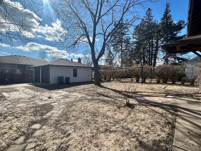 view of yard featuring a garage and fence