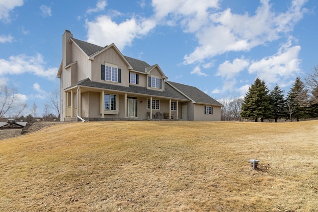 farmhouse-style home with a chimney, a front lawn, and roof with shingles