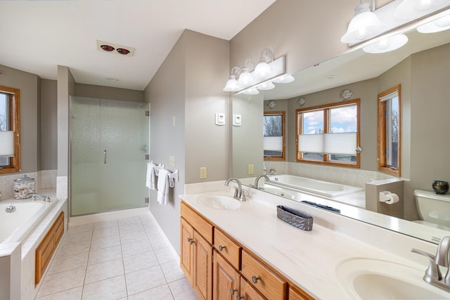 bathroom with double vanity, a sink, a bath, and tile patterned floors