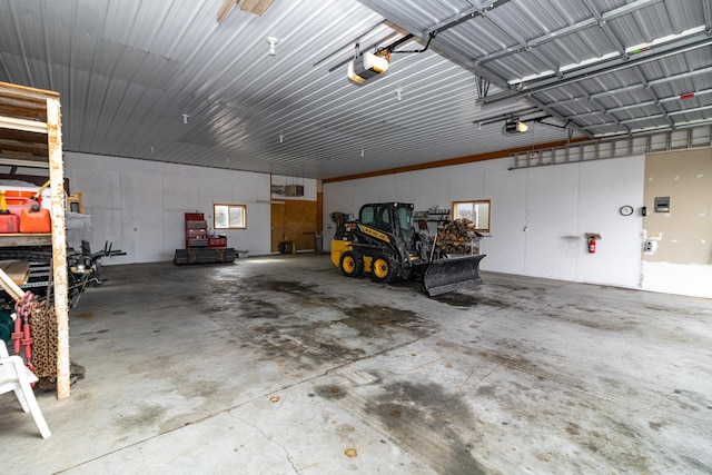 garage featuring metal wall and a garage door opener