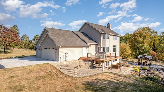 view of front of house with roof with shingles, a gazebo, a deck, driveway, and a front lawn