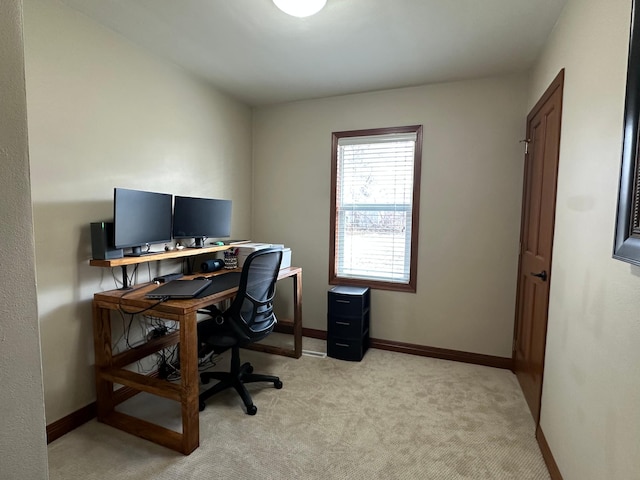 home office with light colored carpet and baseboards