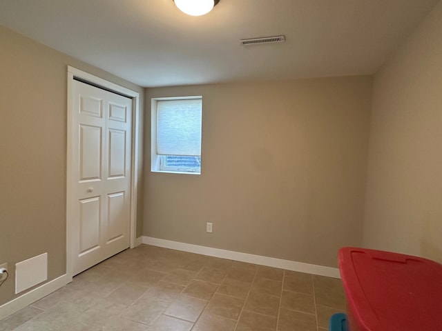 unfurnished bedroom with baseboards and visible vents