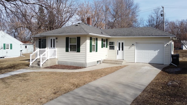 view of front of house with a chimney, a garage, driveway, and roof with shingles