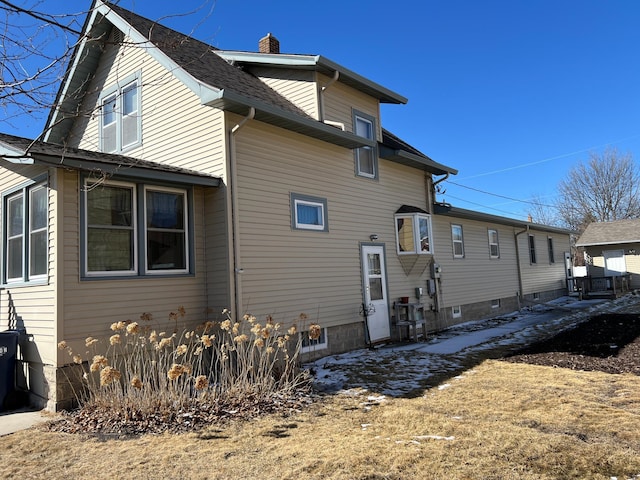 back of property featuring a chimney