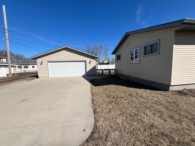 view of side of home with an outbuilding and a detached garage