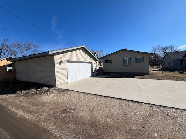 view of home's exterior with an outbuilding and a detached garage