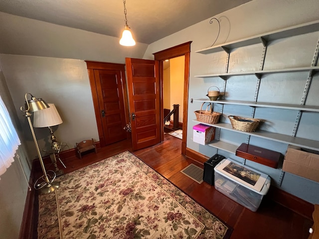 interior space with baseboards and dark wood-type flooring