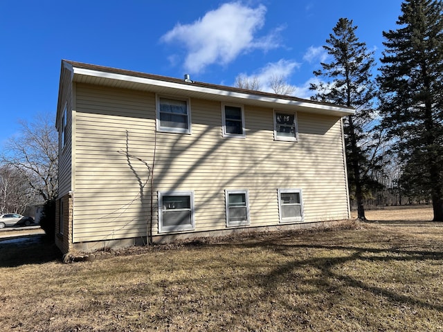 back of house with a lawn