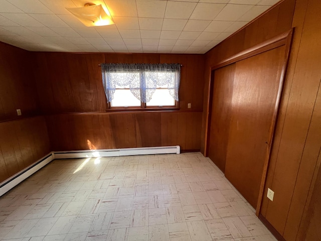 empty room with wood walls and light floors