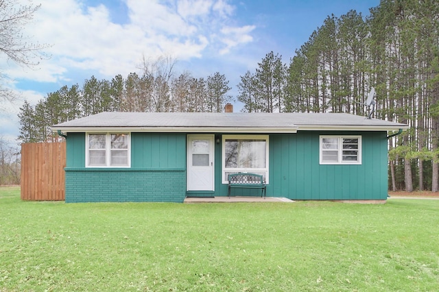 61279 US Highway 169, Hill City, MN 55748 - view of front of property featuring a chimney, brick siding, and a front lawn