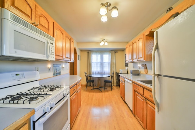 61279 US Highway 169, Hill City, MN 55748 - kitchen with light countertops, a sink, light wood-type flooring, and white appliances